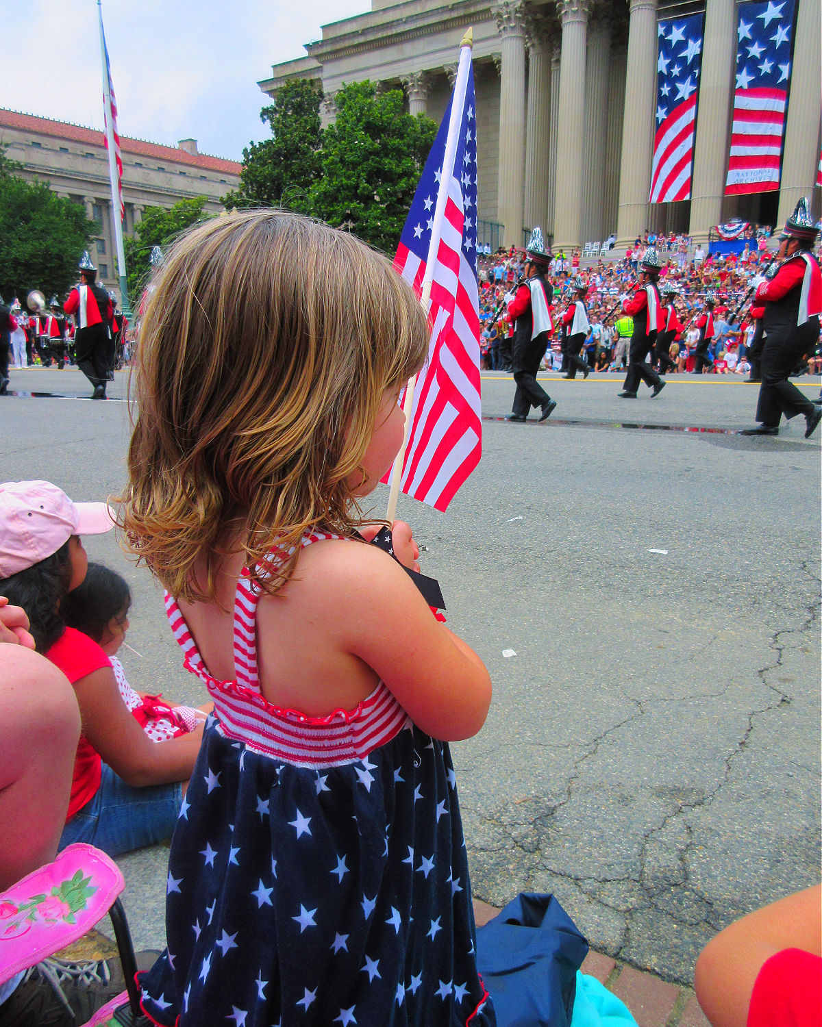 child waving flag at parade